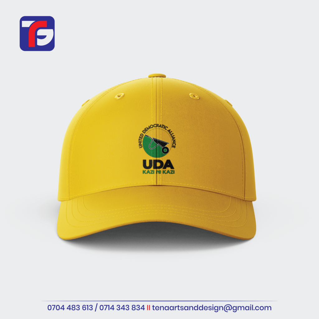 Yellow UDA cap with a curved peak, wheelbarrow logo and Kazi ni Kazi wording on the front.